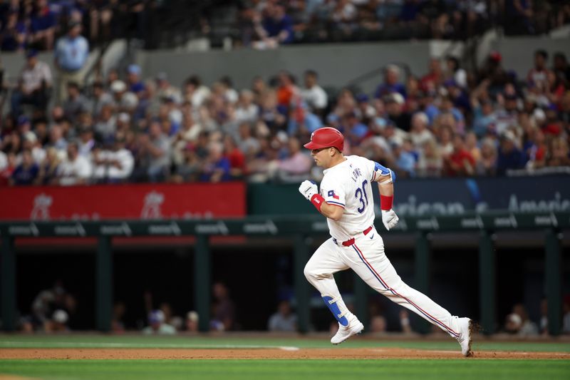 Jun 18, 2024; Arlington, Texas, USA; Texas Rangers first base Nathaniel Lowe (30) runs to second base with a double in the fourth inning against the New York Mets at Globe Life Field. Mandatory Credit: Tim Heitman-USA TODAY Sports