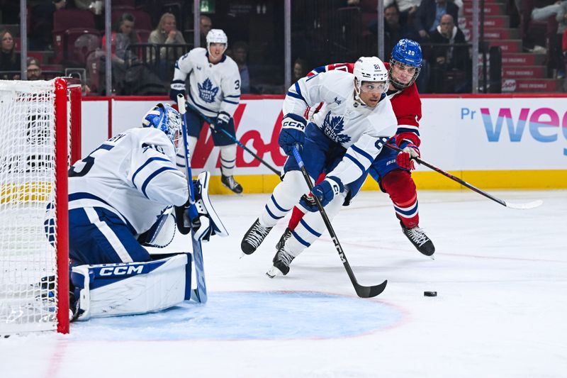 Sep 25, 2025; Montreal, Quebec, CAN; Toronto Maple Leafs forward Dakota Joshua (81) defends the puck against Montreal Canadiens left wing Juraj Slafkovsky (20) during the third period at Bell Centre. Mandatory Credit: David Kirouac-Imagn Images