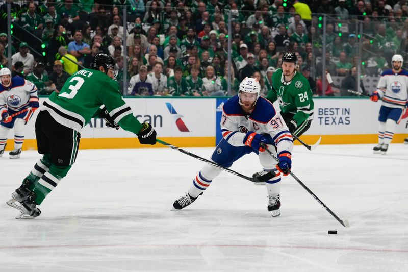 May 31, 2024; Dallas, Texas, USA; Edmonton Oilers center Connor McDavid (97) skates with the puck as Dallas Stars defenseman Chris Tanev (3) defends during the first period between the Dallas Stars and the Edmonton Oilers in game five of the Western Conference Final of the 2024 Stanley Cup Playoffs at American Airlines Center. Mandatory Credit: Chris Jones-USA TODAY Sports