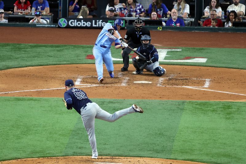 Jul 7, 2024; Arlington, Texas, USA; Texas Rangers shortstop Corey Seager (5) hits a three run home run in the third inning against the Tampa Bay Rays at Globe Life Field. Mandatory Credit: Tim Heitman-USA TODAY Sports