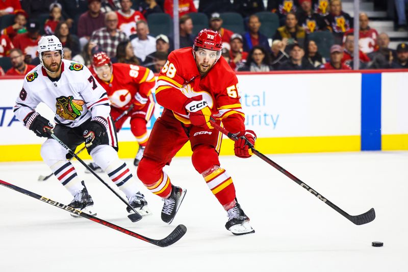 Oct 15, 2024; Calgary, Alberta, CAN; Calgary Flames center Justin Kirkland (58) passes the puck against Chicago Blackhawks during the second period at Scotiabank Saddledome. Mandatory Credit: Sergei Belski-Imagn Images