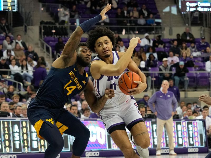 Jan 31, 2023; Fort Worth, Texas, USA; TCU Horned Frogs guard Micah Peavy (0) is fouled while driving to the basket by West Virginia Mountaineers guard Seth Wilson (14) during the first half at Ed and Rae Schollmaier Arena. Mandatory Credit: Chris Jones-USA TODAY Sports