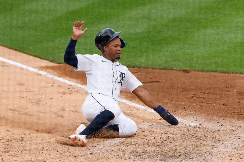 Jun 26, 2025; Detroit, Michigan, USA;  Detroit Tigers outfielder Wenceel PÈrez (46) slides in safe at home in the eighth inning against the Athletics at Comerica Park. Mandatory Credit: Rick Osentoski-Imagn Images