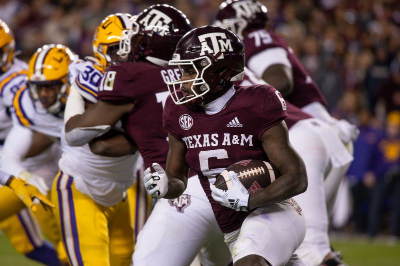 Nov 26, 2022; College Station, Texas, USA; Texas A&M Aggies running back Devon Achane (6) runs against the LSU Tigers during the second half at Kyle Field. Mandatory Credit: Jerome Miron-USA TODAY Sports