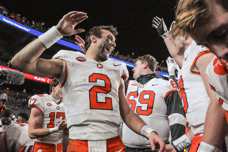 Nov 25, 2023; Columbia, South Carolina, USA; Clemson Tigers quarterback Cade Klubnik (2) celebrates with quarterback Hunter Helms (18) after defeating the South Carolina Gamecocks at Williams-Brice Stadium.  Clemson won 16-7. Mandatory Credit: Ken Ruinard-USA TODAY Sports