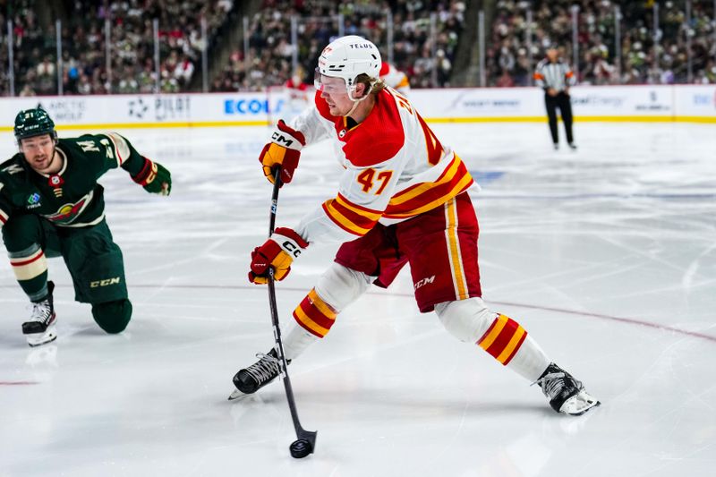 Jan 2, 2024; Saint Paul, Minnesota, USA; Calgary Flames center Connor Zary (47) passes during the third period against the Minnesota Wild at Xcel Energy Center. Mandatory Credit: Brace Hemmelgarn-USA TODAY Sports