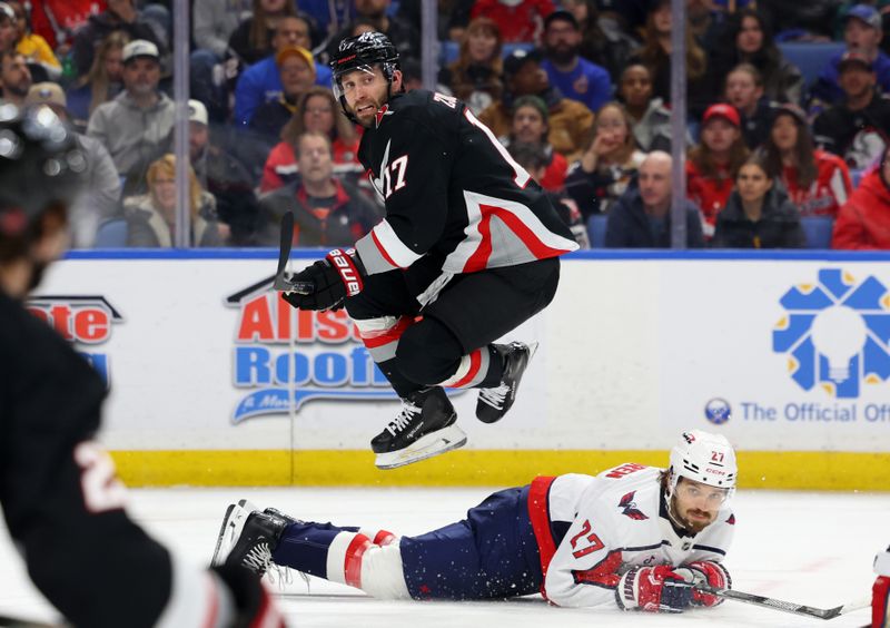 Mar 12, 2026; Buffalo, New York, USA;  Buffalo Sabres left wing Jason Zucker (17) jumps after making a pass to avoid Washington Capitals defenseman Timothy Liljegren (27) during the second period at KeyBank Center. Mandatory Credit: Timothy T. Ludwig-Imagn Images