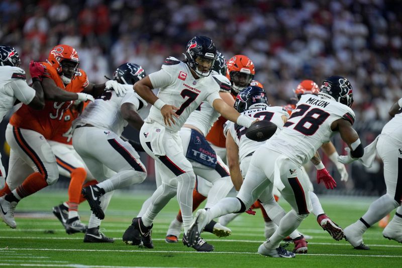 Houston Texans quarterback C.J. Stroud hands off during the first half of an NFL football game against the Chicago Bears Sunday, Sept. 15, 2024, in Houston. (AP Photo/Eric Christian Smith)