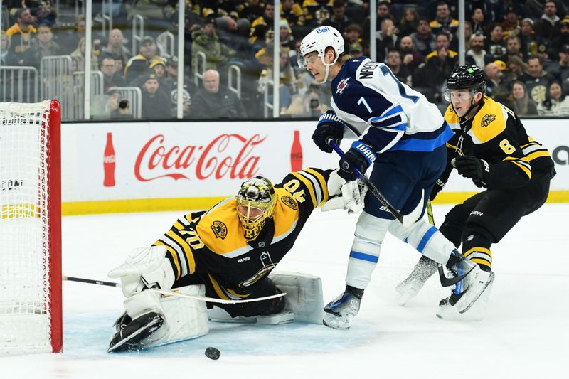 Jan 30, 2025; Boston, Massachusetts, USA; Boston Bruins goaltender Joonas Korpisalo (70) makes a save on Winnipeg Jets center Vladislav Namestnikov (7) during the second period at TD Garden. Mandatory Credit: Bob DeChiara-Imagn Images