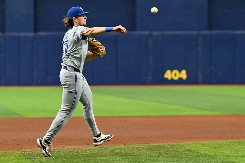 Sep 22, 2024; St. Petersburg, Florida, USA; Toronto Blue Jays third baseman Addison Barger (47) throws to first base in the sixth inning against the Tampa Bay Rays at Tropicana Field. Mandatory Credit: Jonathan Dyer-Imagn Images