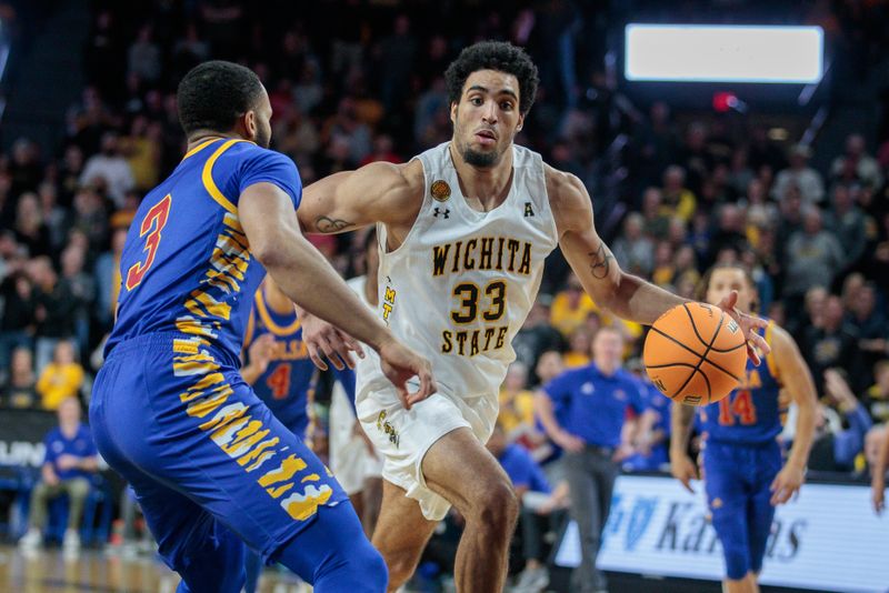 Jan 14, 2023; Wichita, Kansas, USA; Wichita State Shockers forward James Rojas (33) controls the ball against Tulsa Golden Hurricane guard Sterling Gaston-Chapman (3) during the second half at Charles Koch Arena. Mandatory Credit: William Purnell-USA TODAY Sports