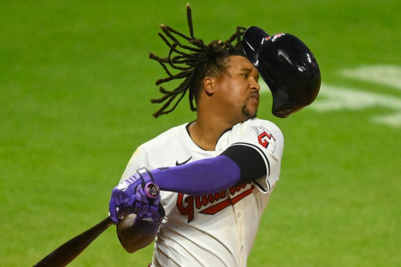 Aug 14, 2024; Cleveland, Ohio, USA; Cleveland Guardians third baseman Jose Ramirez (11) loses his helmet on a swing in the eighth inning against the Chicago Cubs at Progressive Field. Mandatory Credit: David Richard-USA TODAY Sports