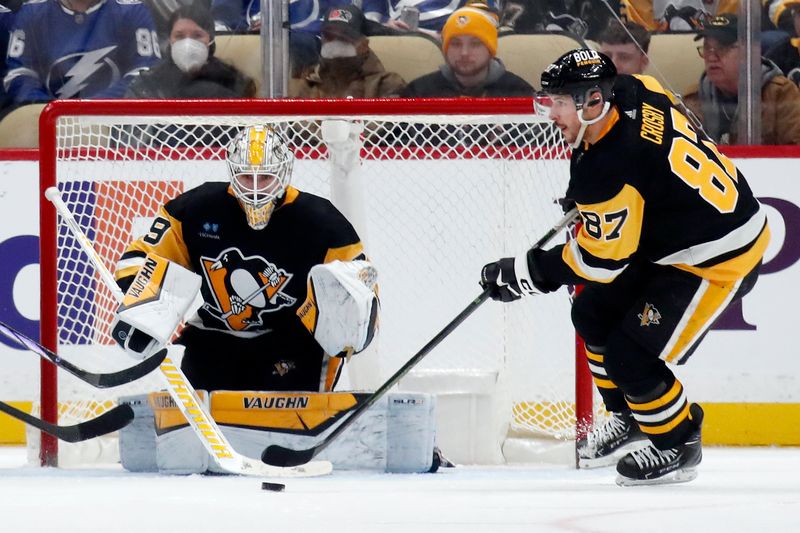 Apr 6, 2024; Pittsburgh, Pennsylvania, USA;  Pittsburgh Penguins center Sidney Crosby (87) clears the puck attire save by Pittsburgh Penguins goaltender Alex Nedeljkovic (39) during the third period against the Tampa Bay Lightning at PPG Paints Arena. The Penguins won 5-4. Mandatory Credit: Charles LeClaire-USA TODAY Sports