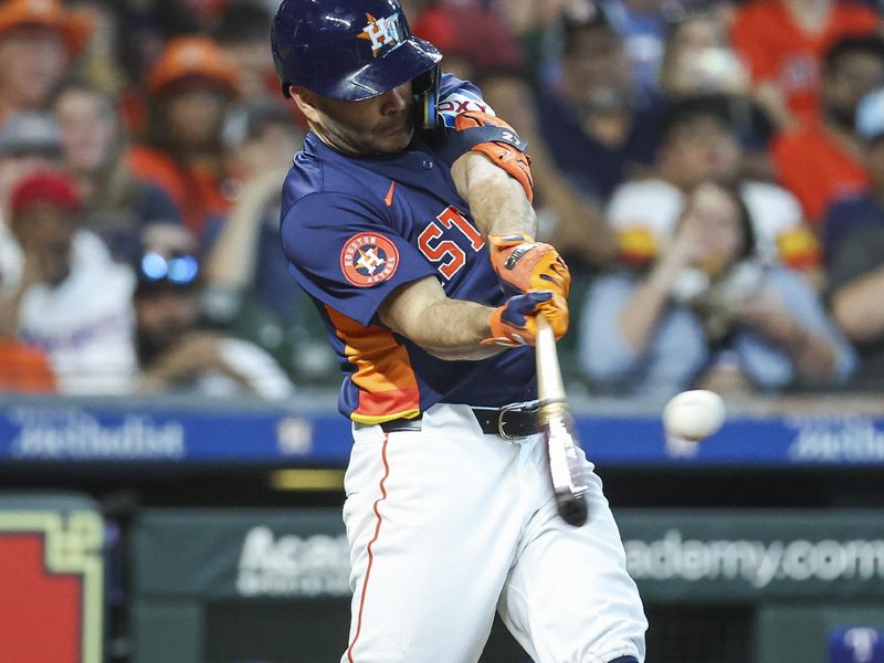 Apr 14, 2024; Houston, Texas, USA; Houston Astros second baseman Jose Altuve (27) hits a home run during the third inning against the Texas Rangers at Minute Maid Park. Mandatory Credit: Troy Taormina-USA TODAY Sports