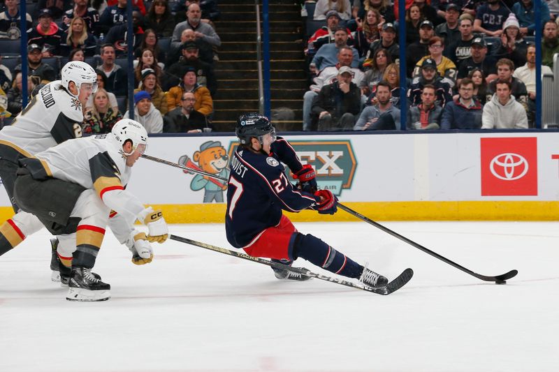 Mar 4, 2024; Columbus, Ohio, USA; Columbus Blue Jackets defenseman Adam Boqvist (27) shoots on goal as he falls to the ice against the Vegas Golden Knights during the second period at Nationwide Arena. Mandatory Credit: Russell LaBounty-USA TODAY Sports