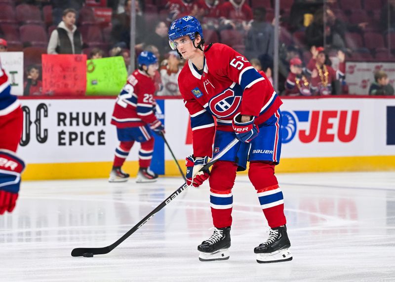 Oct 21, 2023; Montreal, Quebec, CAN;Montreal Canadiens defenseman Justin Barron (52) skates with a puck during warm-up at his first game of the season before the game against the Washington Capitals at Bell Centre. Mandatory Credit: David Kirouac-USA TODAY Sports