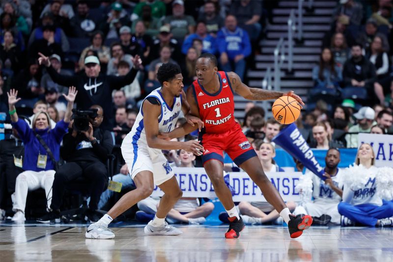 Mar 17, 2023; Columbus, OH, USA; Florida Atlantic Owls guard Johnell Davis (1) dribbles the ball defended by Memphis Tigers guard Elijah McCadden (0) in the first half at Nationwide Arena. Mandatory Credit: Rick Osentoski-USA TODAY Sports