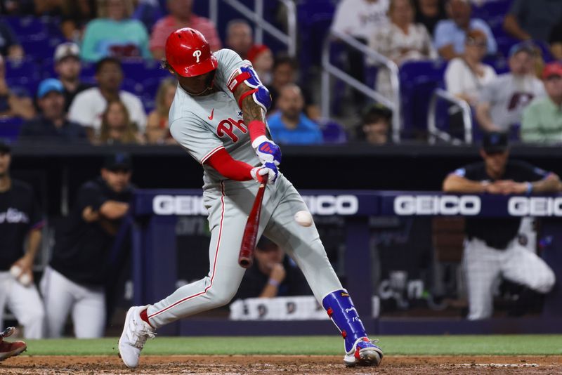 May 10, 2024; Miami, Florida, USA; Philadelphia Phillies left fielder Cristian Pache (19) hits an RBI double against the Miami Marlins during the fourth inning at loanDepot Park. Mandatory Credit: Sam Navarro-USA TODAY Sports