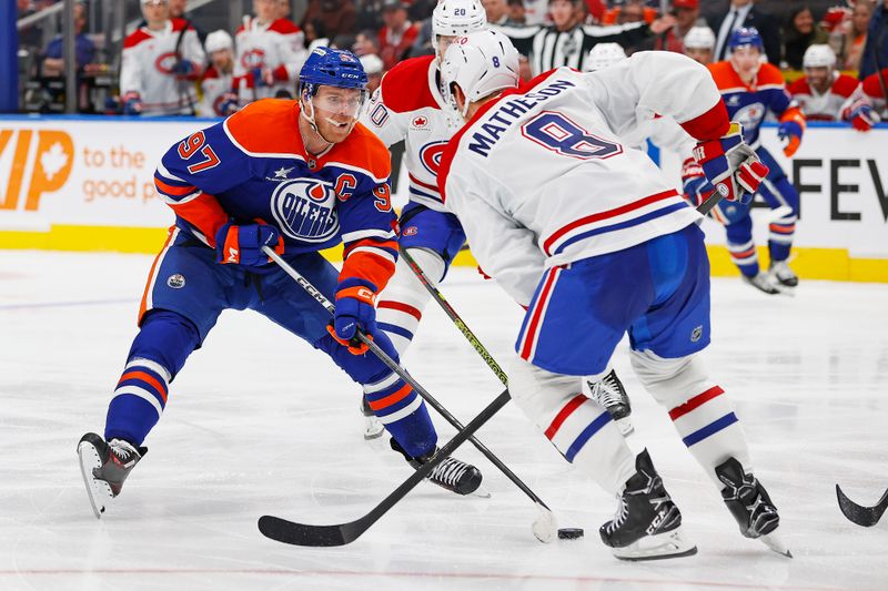 Mar 6, 2025; Edmonton, Alberta, CAN; Edmonton Oilers forward Connor McDavid (97) tries to move the puck past Montreal Canadiens defensemen Mike Matheson (8) during the third period at Rogers Place. Mandatory Credit: Perry Nelson-Imagn Images