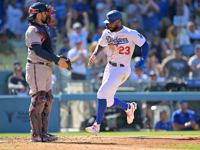 Sep 3, 2023; Los Angeles, California, USA; Atlanta Braves catcher Travis d'Arnaud (16) looks on as Los Angeles Dodgers right fielder Jason Heyward (23) crosses the plate on a single by Los Angeles Dodgers center fielder James Outman (33) in the eighth inning at Dodger Stadium. Mandatory Credit: Jayne Kamin-Oncea-USA TODAY Sports