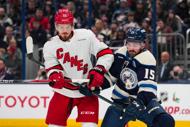 Nov 23, 2024; Columbus, Ohio, USA;  Carolina Hurricanes center Jack Roslovic (96) reacts as he deflects the puck in front of Columbus Blue Jackets defenseman Dante Fabbro (15) in the first period at Nationwide Arena. Mandatory Credit: Aaron Doster-Imagn Images