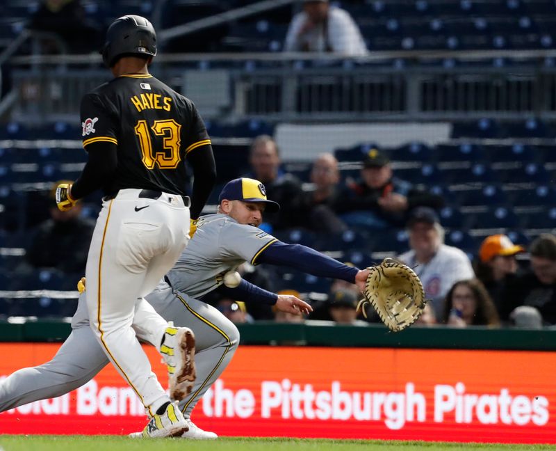 Apr 22, 2024; Pittsburgh, Pennsylvania, USA;  Pittsburgh Pirates third baseman Ke'Bryan Hayes (13) is safe on an infield single as Milwaukee Brewers first baseman Jake Bauers (9) can not handle the throw during the sixth inning at PNC Park. Mandatory Credit: Charles LeClaire-USA TODAY Sports