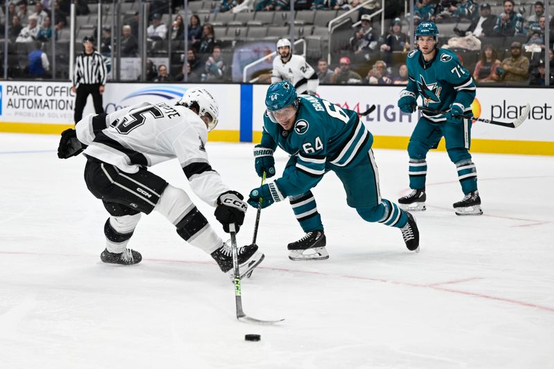 Oct 29, 2024; San Jose, California, USA; San Jose Sharks center Mikael Granlund (64) and Los Angeles Kings center Alex Turcotte (15) reach for a loose puck in the first period at SAP Center at San Jose. Mandatory Credit: Eakin Howard-Imagn Images