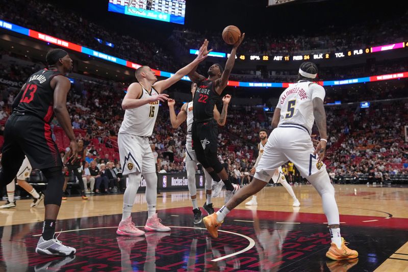 MIAMI, FL - MARCH 13: Jimmy Butler #22 of the Miami Heat shoots the ball during the game against the Denver Nuggets on March 13, 2024 at Kaseya Center in Miami, Florida. NOTE TO USER: User expressly acknowledges and agrees that, by downloading and or using this Photograph, user is consenting to the terms and conditions of the Getty Images License Agreement. Mandatory Copyright Notice: Copyright 2024 NBAE (Photo by Eric Espada/NBAE via Getty Images)