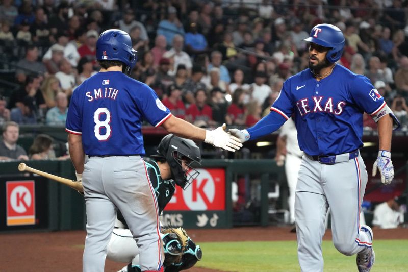 Sep 11, 2024; Phoenix, Arizona, USA; Texas Rangers second baseman Marcus Semien (2) celebrates with Josh Smith (8) after hitting a solo home run against the Arizona Diamondbacks in the third inning at Chase Field. Mandatory Credit: Rick Scuteri-Imagn Images