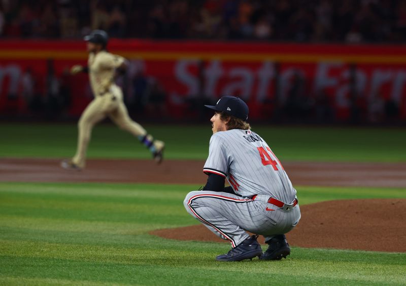 Jun 25, 2024; Phoenix, Arizona, USA; Minnesota Twins pitcher Joe Ryan reacts after giving up a home run to Arizona Diamondbacks infielder Ketel Marte in the first inning at Chase Field. Mandatory Credit: Mark J. Rebilas-USA TODAY Sports