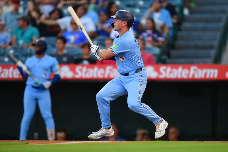 Aug 12, 2024; Anaheim, California, USA; Toronto Blue Jays second baseman Will Wagner (7) hits a double in his major league debut against the Los Angeles Angels during the second inning at Angel Stadium. Mandatory Credit: Gary A. Vasquez-USA TODAY Sports