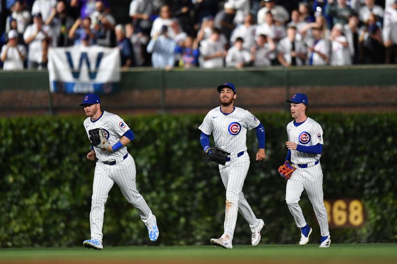 Aug 20, 2024; Chicago, Illinois, USA; Chicago Cubs left fielder Ian Happ (left), right fielder Cody Bellinger (center), and center fielder Pete Crow-Armstrong (right) celebrate after defeating the Detroit Tigers at Wrigley Field. Mandatory Credit: Patrick Gorski-USA TODAY Sports