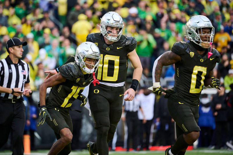 Nov 4, 2023; Eugene, Oregon, USA; Oregon Ducks wide receiver Tez Johnson (15) celebrates his touchdown reception with quarterback Bo Nix (10) during the first half against the California Golden Bears at Autzen Stadium. Mandatory Credit: Troy Wayrynen-USA TODAY Sports