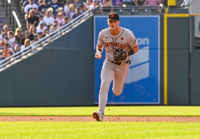 Jul 20, 2024; Denver, Colorado, USA; San Francisco Giants outfielder Tyler Fitzgerald (49) fields the ball against the Colorado Rockies second inning at Coors Field. Mandatory Credit: John Leyba-USA TODAY Sports