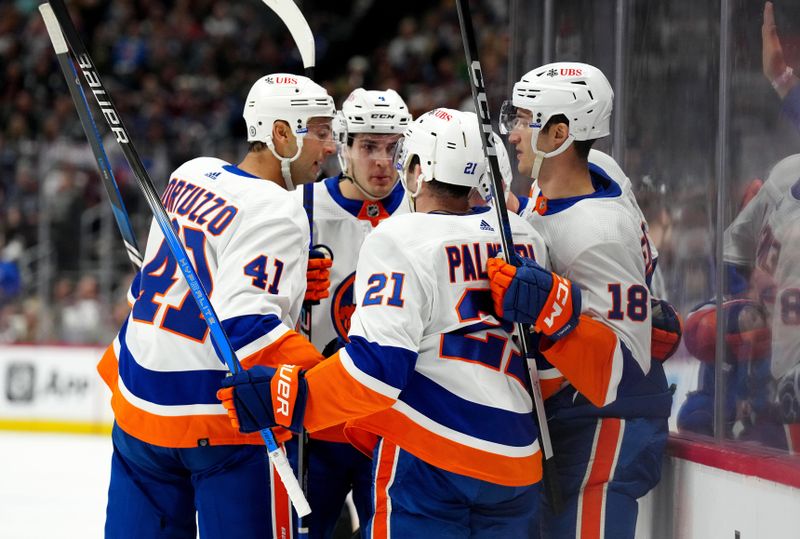 Jan 2, 2024; Denver, Colorado, USA; New York Islanders left wing Pierre Engvall (18) celebrates his goal with center Kyle Palmieri (21) and defenseman Robert Bortuzzo (41) and efenseman Samuel Bolduc (4) in the first period against the Colorado Avalanche at Ball Arena. Mandatory Credit: Ron Chenoy-USA TODAY Sports