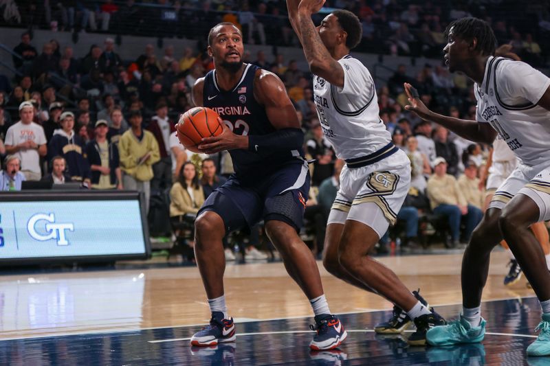 Jan 20, 2024; Atlanta, Georgia, USA; Virginia Cavaliers forward Jordan Minor (22) is defended by Georgia Tech Yellow Jackets forward Tyzhaun Claude (12) in the first half at McCamish Pavilion. Mandatory Credit: Brett Davis-USA TODAY Sports