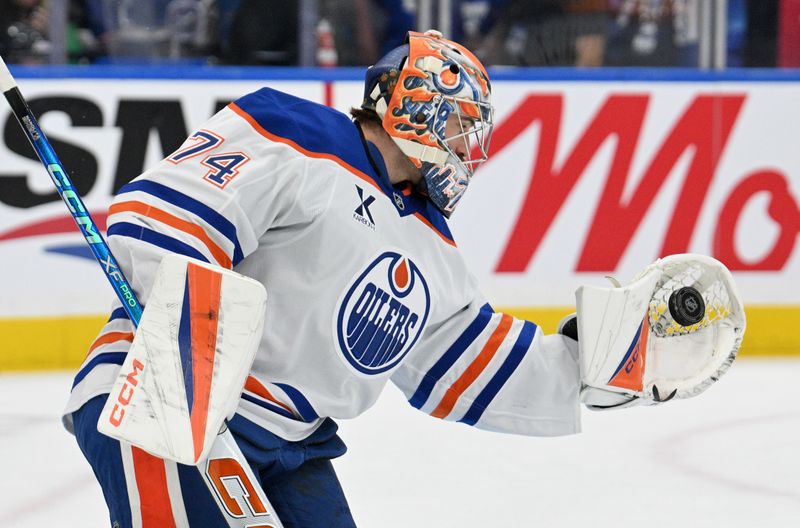 Nov 16, 2024; Toronto, Ontario, CAN;  Edmonton Oilers goalie Stuart Skinner (74) catches the puck as he warms up before playing the Toronto Maple Leafs at Scotiabank Arena. Mandatory Credit: Dan Hamilton-Imagn Images