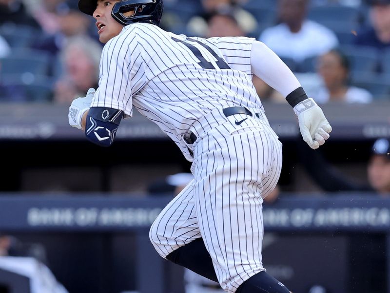 Apr 1, 2023; Bronx, New York, USA; New York Yankees shortstop Anthony Volpe (11) runs out a single against the San Francisco Giants during the second inning at Yankee Stadium. The hit was hit first major league hit. Mandatory Credit: Brad Penner-USA TODAY Sports