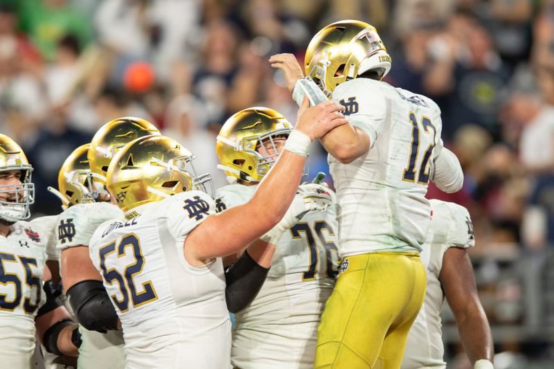 Dec 30, 2022; Jacksonville, FL, USA; Notre Dame Fighting Irish quarterback Tyler Buchner (12) celebrates a touchdown against South Carolina Gamecocks in the third quarter in the 2022 Gator Bowl at TIAA Bank Field. Mandatory Credit: Jeremy Reper-USA TODAY Sports