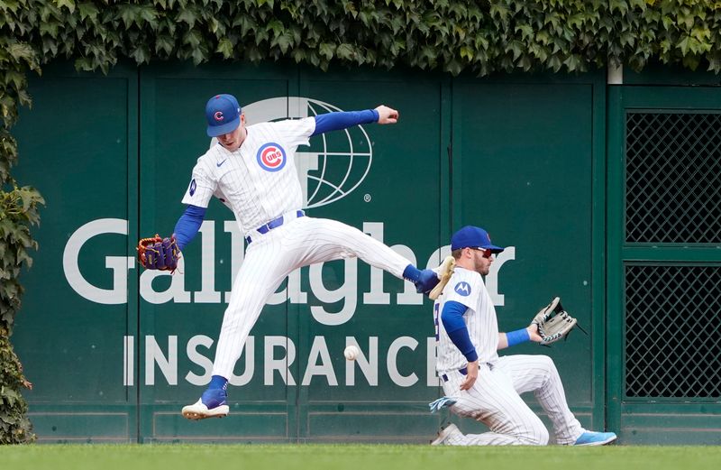 Sep 27, 2024; Chicago, Illinois, USA; Chicago Cubs outfielder Pete Crow-Armstrong (left) and outfielder Kevin Alcantra (back) cannot catch a double hit by Cincinnati Reds shortstop Elly De La Cruz (not pictured) during the first inning at Wrigley Field. Mandatory Credit: David Banks-Imagn Images