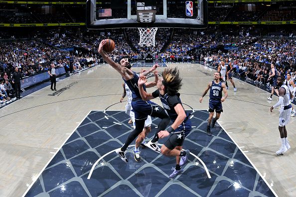 ORLANDO, FL - NOVEMBER 6: Goga Bitadze #35 of the Orlando Magic drives to the basket during the game against the Dallas Mavericks on November 6, 2023 at Amway Center in Orlando, Florida. NOTE TO USER: User expressly acknowledges and agrees that, by downloading and or using this photograph, User is consenting to the terms and conditions of the Getty Images License Agreement. Mandatory Copyright Notice: Copyright 2023 NBAE (Photo by Fernando Medina/NBAE via Getty Images)