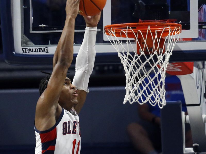 Feb 18, 2023; Oxford, Mississippi, USA; Mississippi Rebels guard Matthew Murrell (11) dunks during the first half against the Mississippi State Bulldogs at The Sandy and John Black Pavilion at Ole Miss. Mandatory Credit: Petre Thomas-USA TODAY Sports