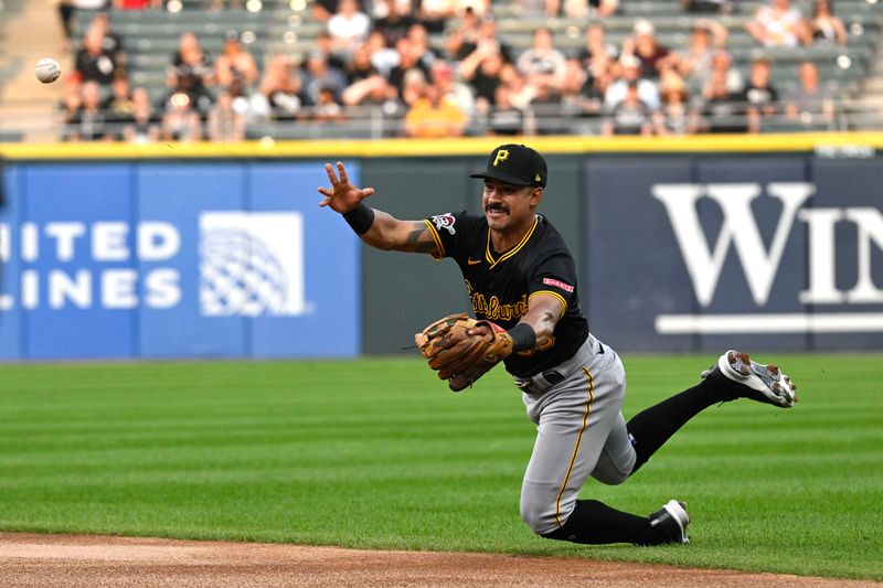 Jul 12, 2024; Chicago, Illinois, USA;   Pittsburgh Pirates second baseman  Nick Gonzales (39) trips while throwing to first base during the first inning at Guaranteed Rate Field. Mandatory Credit: Matt Marton-USA TODAY Sports