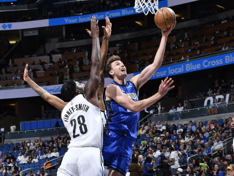 ORLANDO, FL - FEBRUARY 27: Franz Wagner #22 of the Orlando Magic drives to the basket during the game against the Brooklyn Nets on February 27, 2024 at the Kia Center in Orlando, Florida. NOTE TO USER: User expressly acknowledges and agrees that, by downloading and or using this photograph, User is consenting to the terms and conditions of the Getty Images License Agreement. Mandatory Copyright Notice: Copyright 2024 NBAE (Photo by Gary Bassing/NBAE via Getty Images)