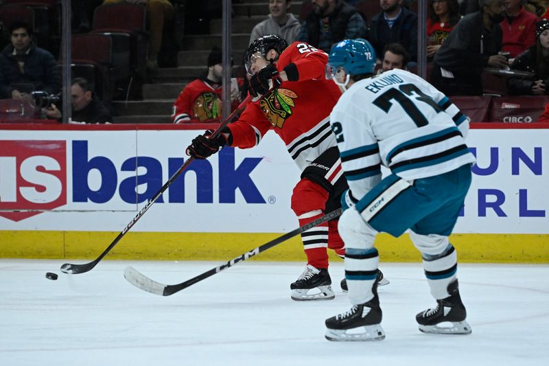 Jan 16, 2024; Chicago, Illinois, USA; Chicago Blackhawks defenseman Nikita Zaitsev (22) moves the puck against San Jose Sharks left wing William Eklund (72) during the first period at United Center. Mandatory Credit: Matt Marton-USA TODAY Sports