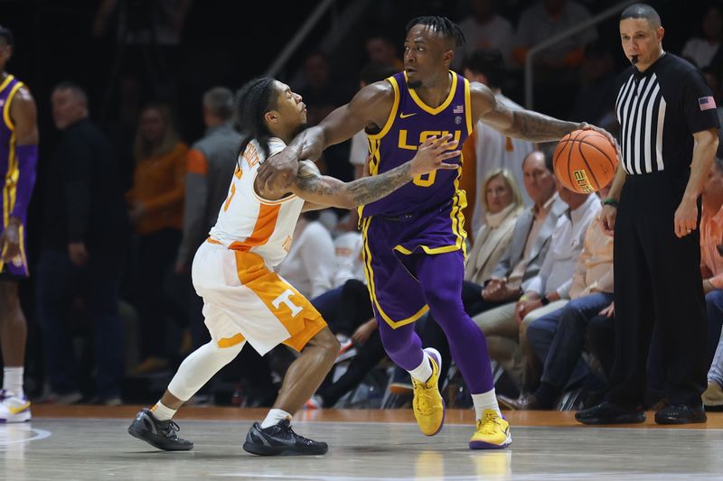 Feb 7, 2024; Knoxville, Tennessee, USA; LSU Tigers guard Trae Hannibal (0) is defended by Tennessee Volunteers guard Zakai Zeigler (5) during the second half at Thompson-Boling Arena at Food City Center. Mandatory Credit: Randy Sartin-USA TODAY Sports