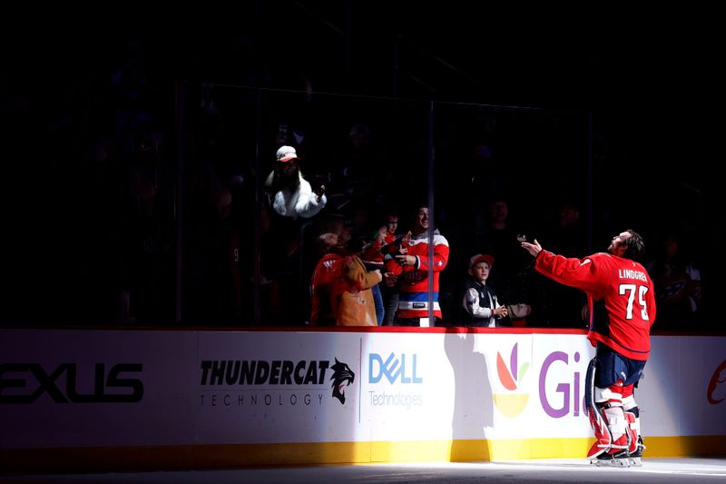 Nov 17, 2025; Washington, District of Columbia, USA; Washington Capitals goaltender Charlie Lindgren (79) tosses a puck into the stands after being names number one star of the game against the Los Angeles Kings at Capital One Arena. Mandatory Credit: Geoff Burke-Imagn Images