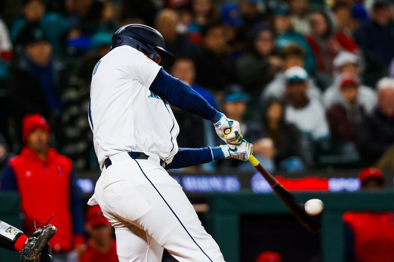 Apr 29, 2025; Seattle, Washington, USA; Seattle Mariners designated hitter Jorge Polanco (7) hits a two-run home run against the Los Angeles Angels during the seventh inning at T-Mobile Park. Mandatory Credit: Joe Nicholson-Imagn Images