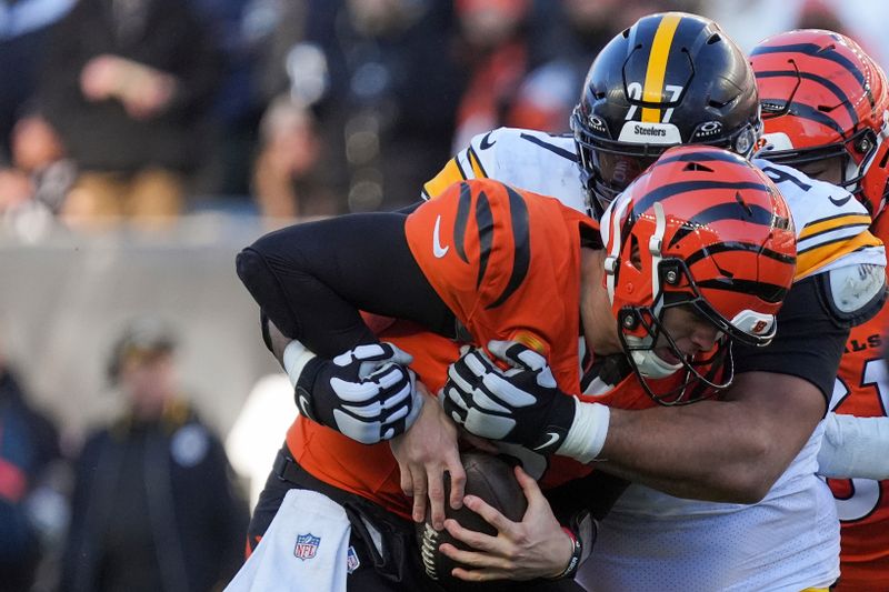 Pittsburgh Steelers defensive tackle Cameron Heyward, right, sacks Cincinnati Bengals quarterback Joe Burrow during the second half of an NFL football game Sunday, Dec. 1, 2024, in Cincinnati. (AP Photo/Joshua A. Bickel)