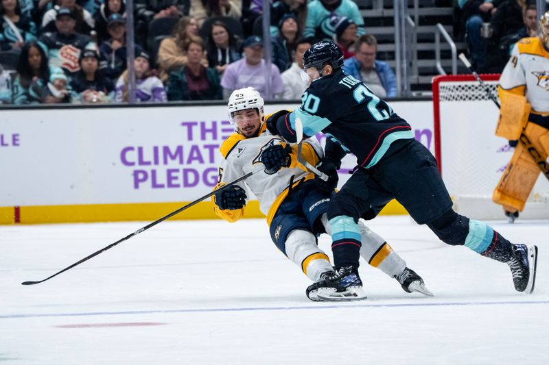 Nov 20, 2024; Seattle, Washington, USA;  Seattle Kraken forward Eeli Tolvanen (20) knocks Nashville Predators defenseman Alexandre Carrier (45) to the ice during the first period at Climate Pledge Arena. Mandatory Credit: Stephen Brashear-Imagn Images